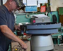 Close view of a vibratory feeder spring bank and drive area during tuning